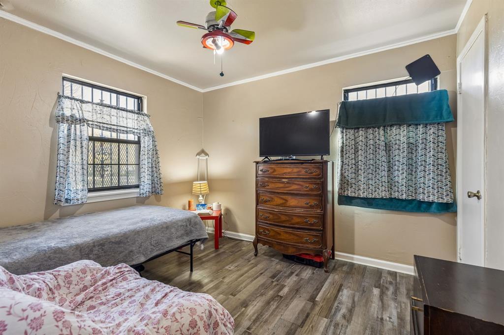 2622 Centerville Road Dallas, TX 75228 - Photo 13 of 22 a bedroom with furniture and a flat screen tv