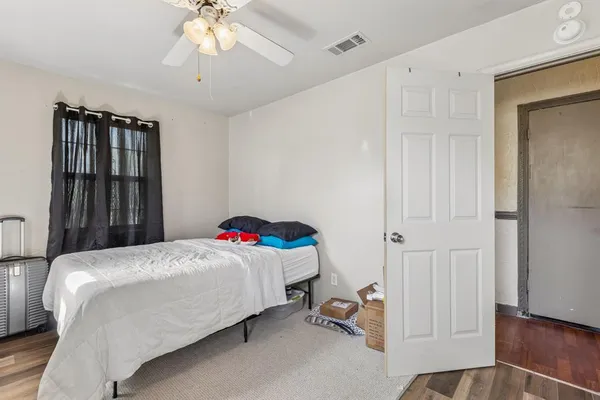 a bedroom with a bed and a chandelier