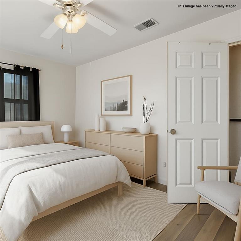 2622 Centerville Road Dallas, TX 75228 - Photo 16 of 22 a bedroom with a bed and a chandelier