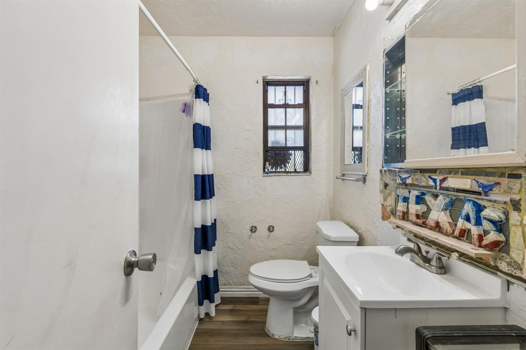 2622 Centerville Road Dallas, TX 75228 - Photo 17 of 22 a bathroom with a sink toilet and shower