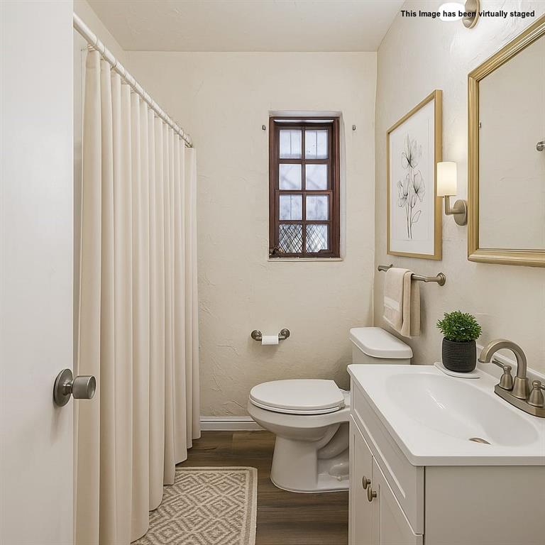 2622 Centerville Road Dallas, TX 75228 - Photo 18 of 22 a bathroom with a white toilet sitting next to a bathroom sink