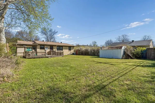 a view of a house with a backyard