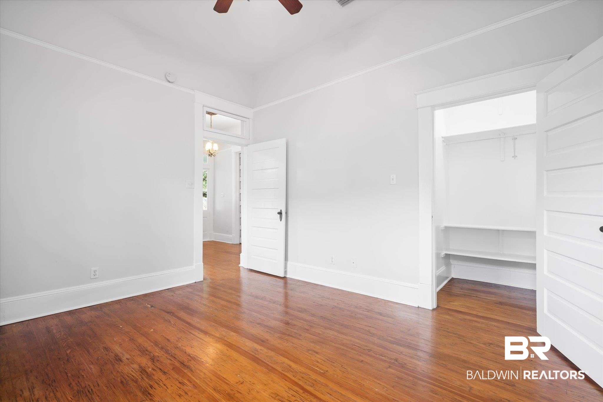 14 South Monterey Street Mobile, AL 36604 - Photo 32 of 41 Unfurnished bedroom with hardwood / wood-style floors, ceiling fan, and a closet