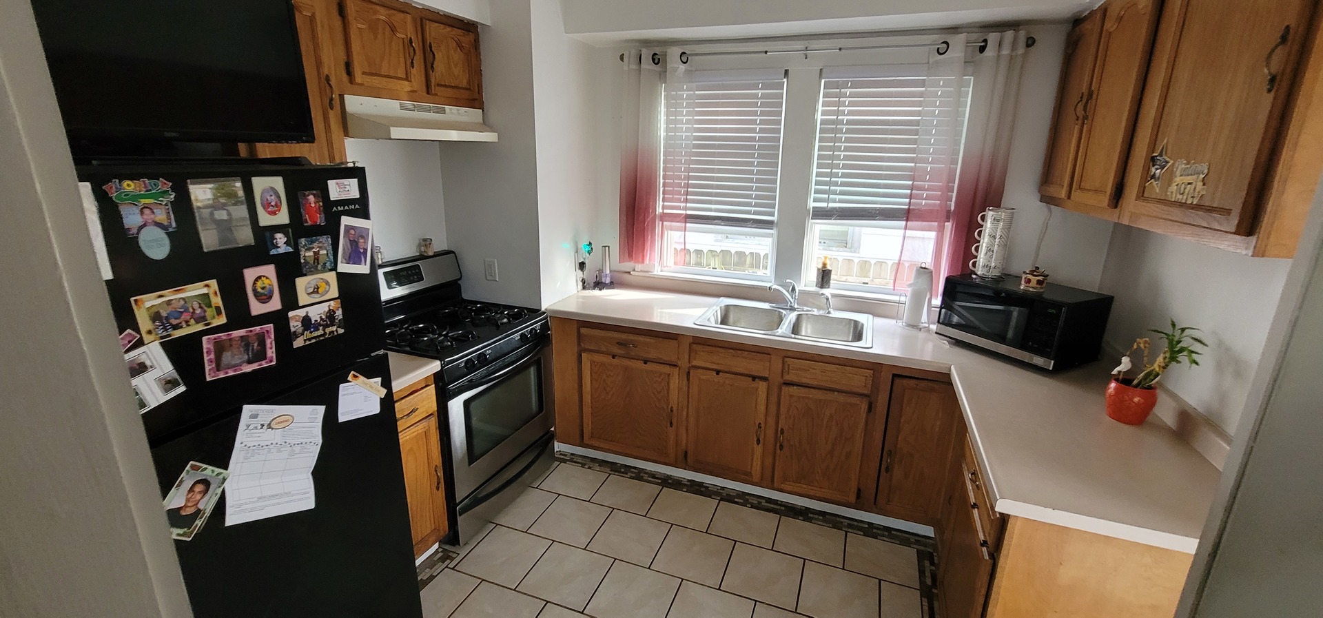 709 Ave C Sterling, IL 61081 - Photo 8 of 16 a kitchen with stainless steel appliances a sink stove and cabinets