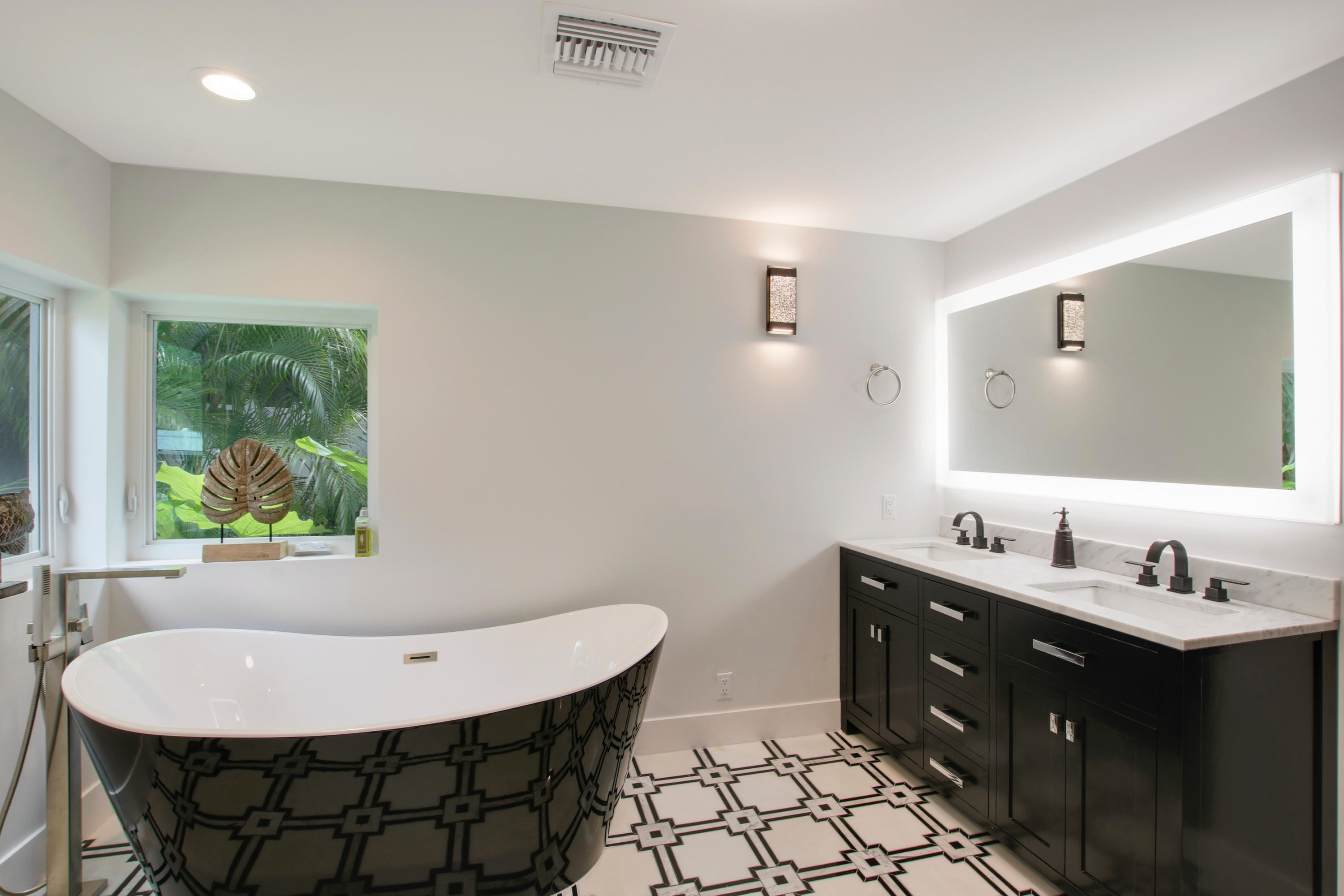 1150 Singer Drive Riviera Beach, FL 33404 - Photo 13 of 20 a bathroom with a double vanity sink mirror and toilet