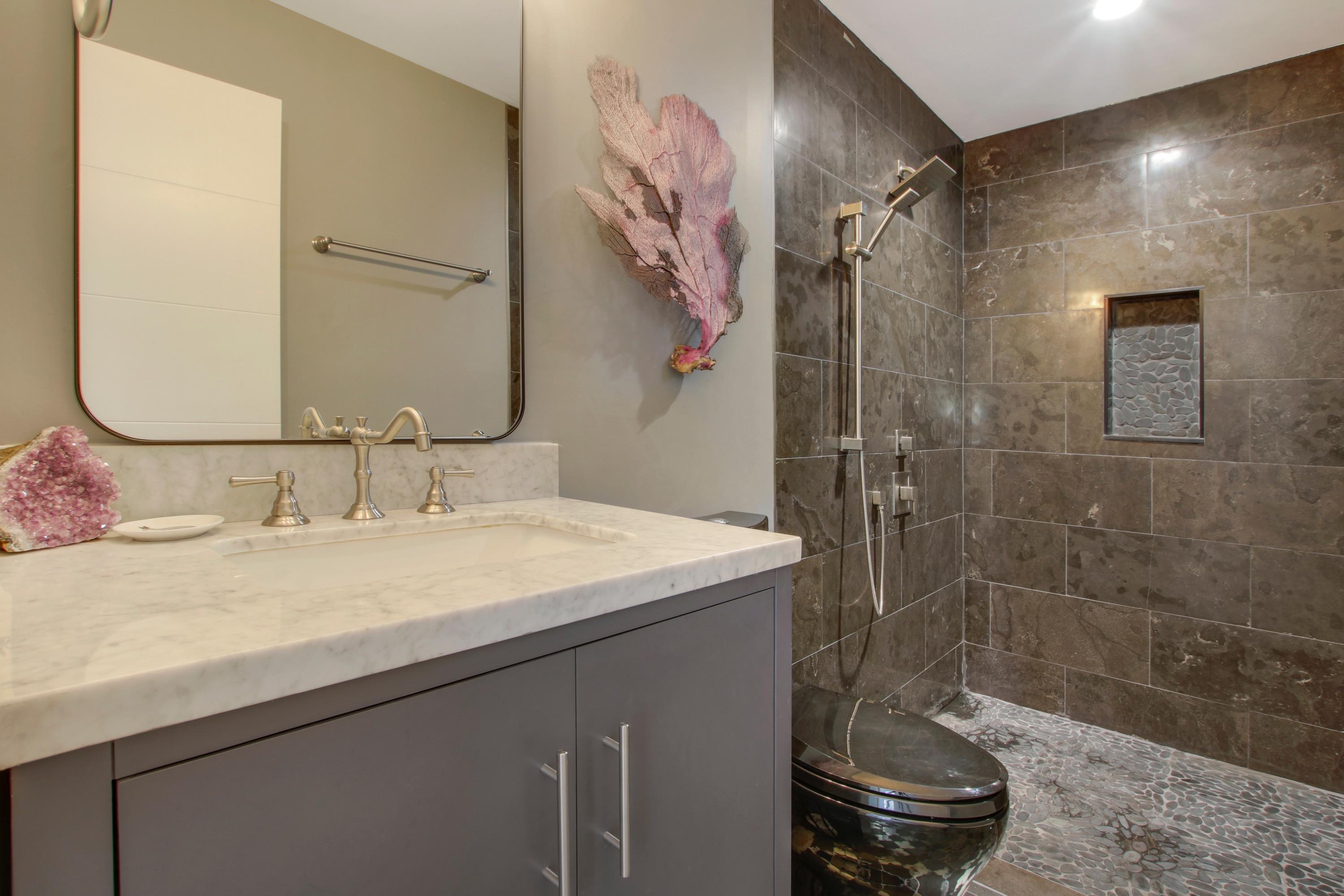 1150 Singer Drive Riviera Beach, FL 33404 - Photo 15 of 20 a bathroom with a sink a toilet and shower