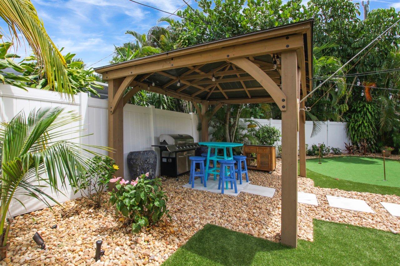1150 Singer Drive Riviera Beach, FL 33404 - Photo 18 of 20 a view of house with backyard and sitting area