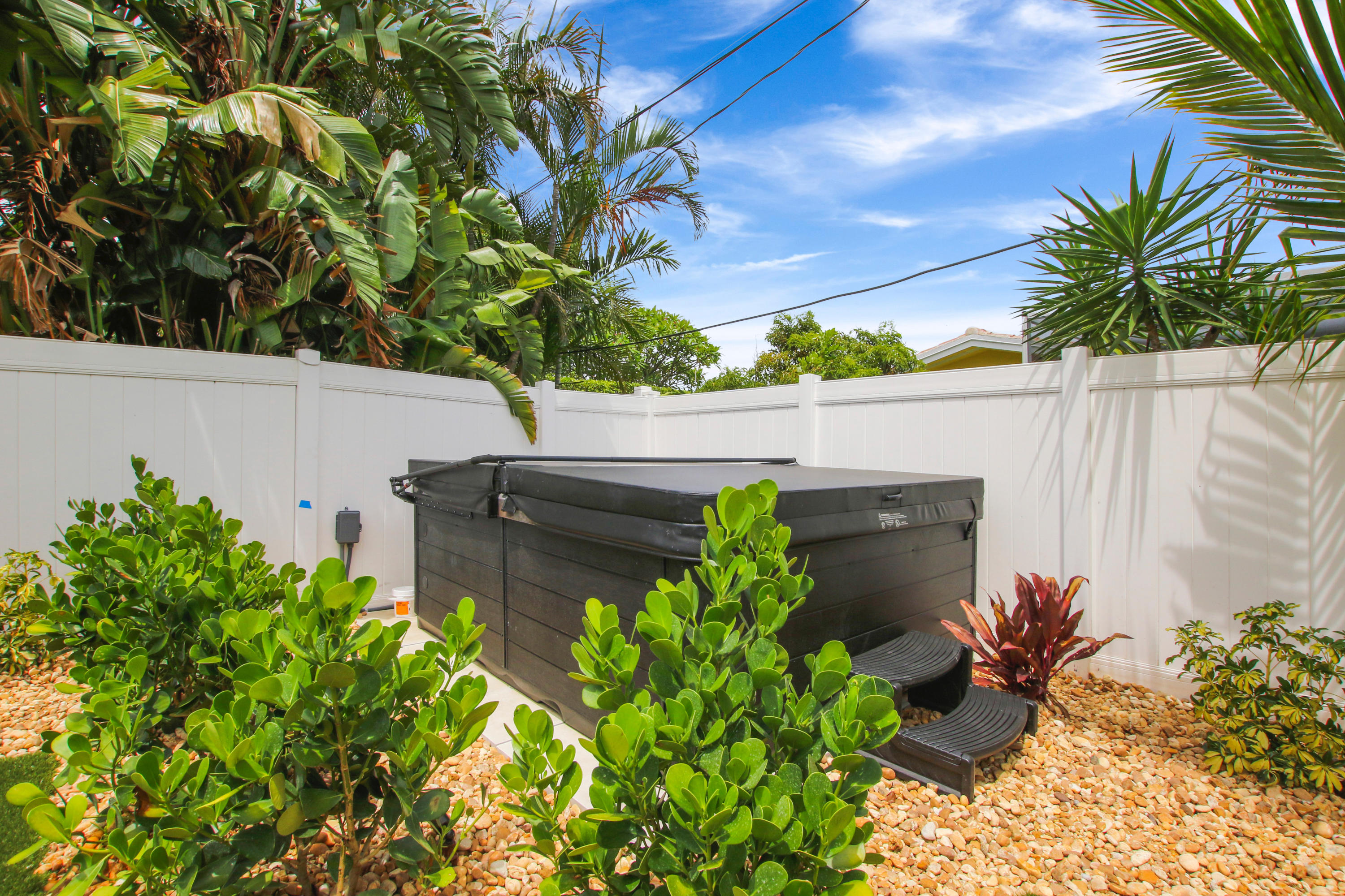 1150 Singer Drive Riviera Beach, FL 33404 - Photo 19 of 20 a flower plants with wooden fence