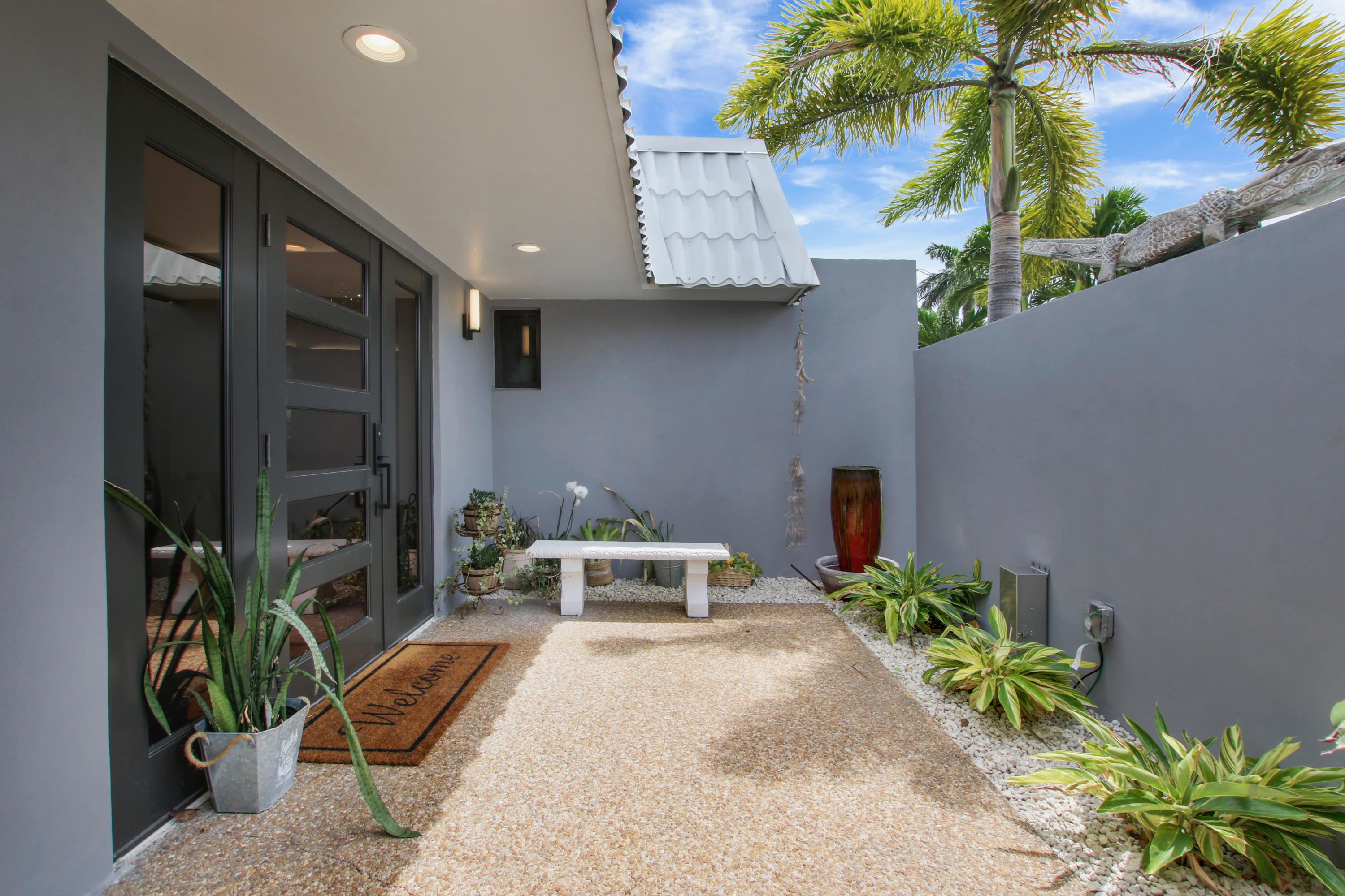 1150 Singer Drive Riviera Beach, FL 33404 - Photo 2 of 20 a front view of a house with garden