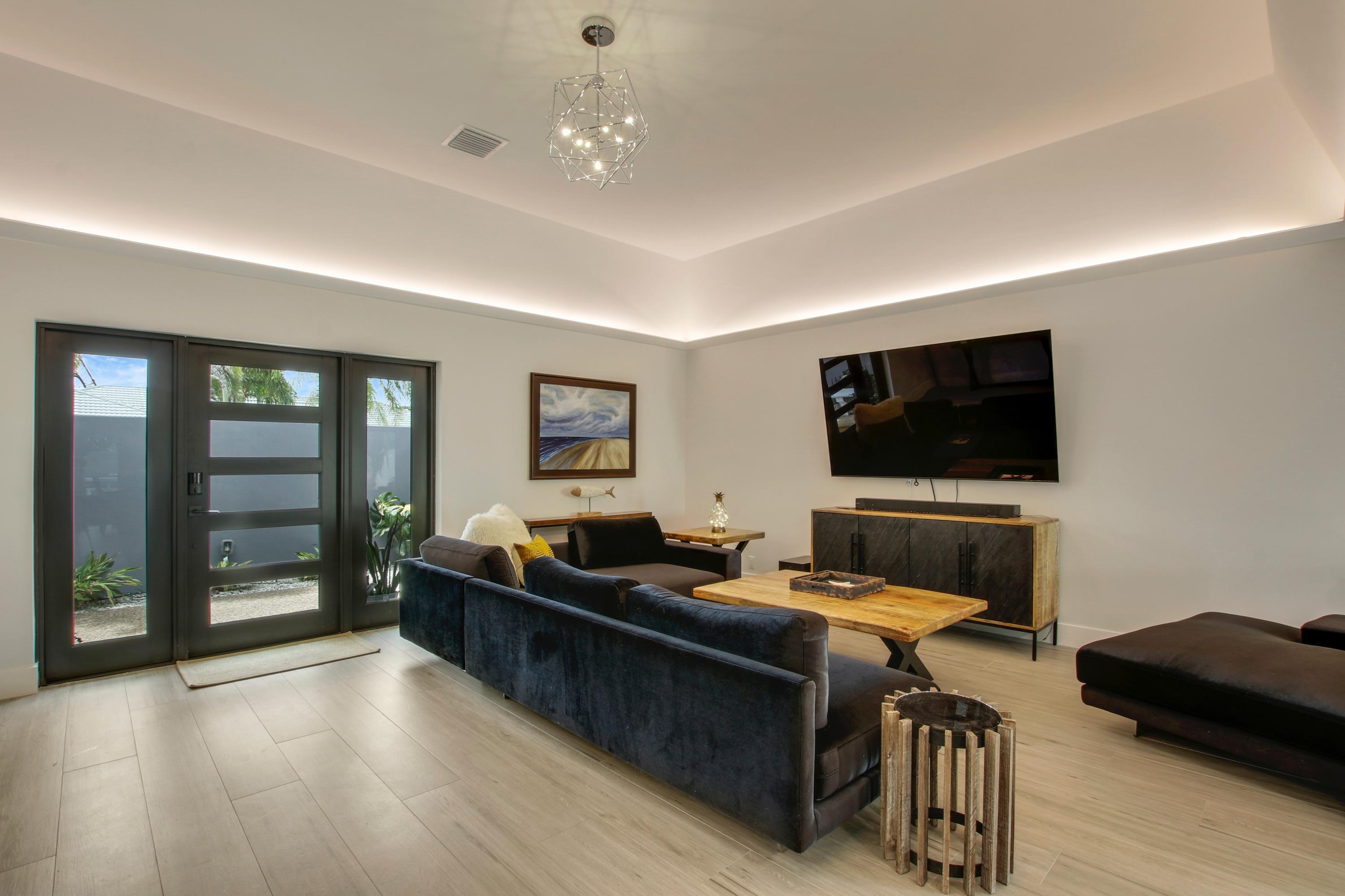 1150 Singer Drive Riviera Beach, FL 33404 - Photo 3 of 20 a living room with furniture and a flat screen tv