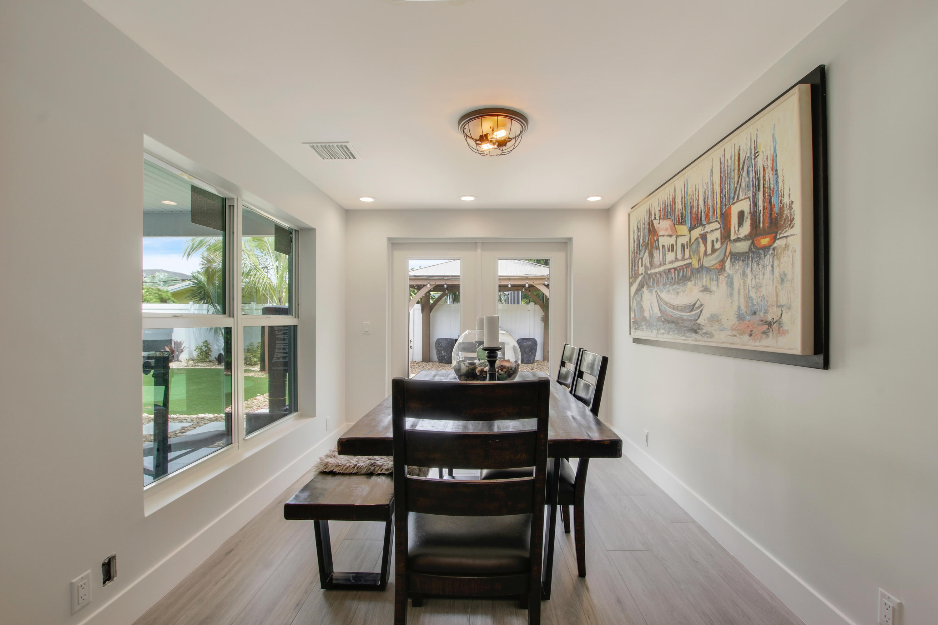 1150 Singer Drive Riviera Beach, FL 33404 - Photo 6 of 20 a dining room with furniture and wooden floor