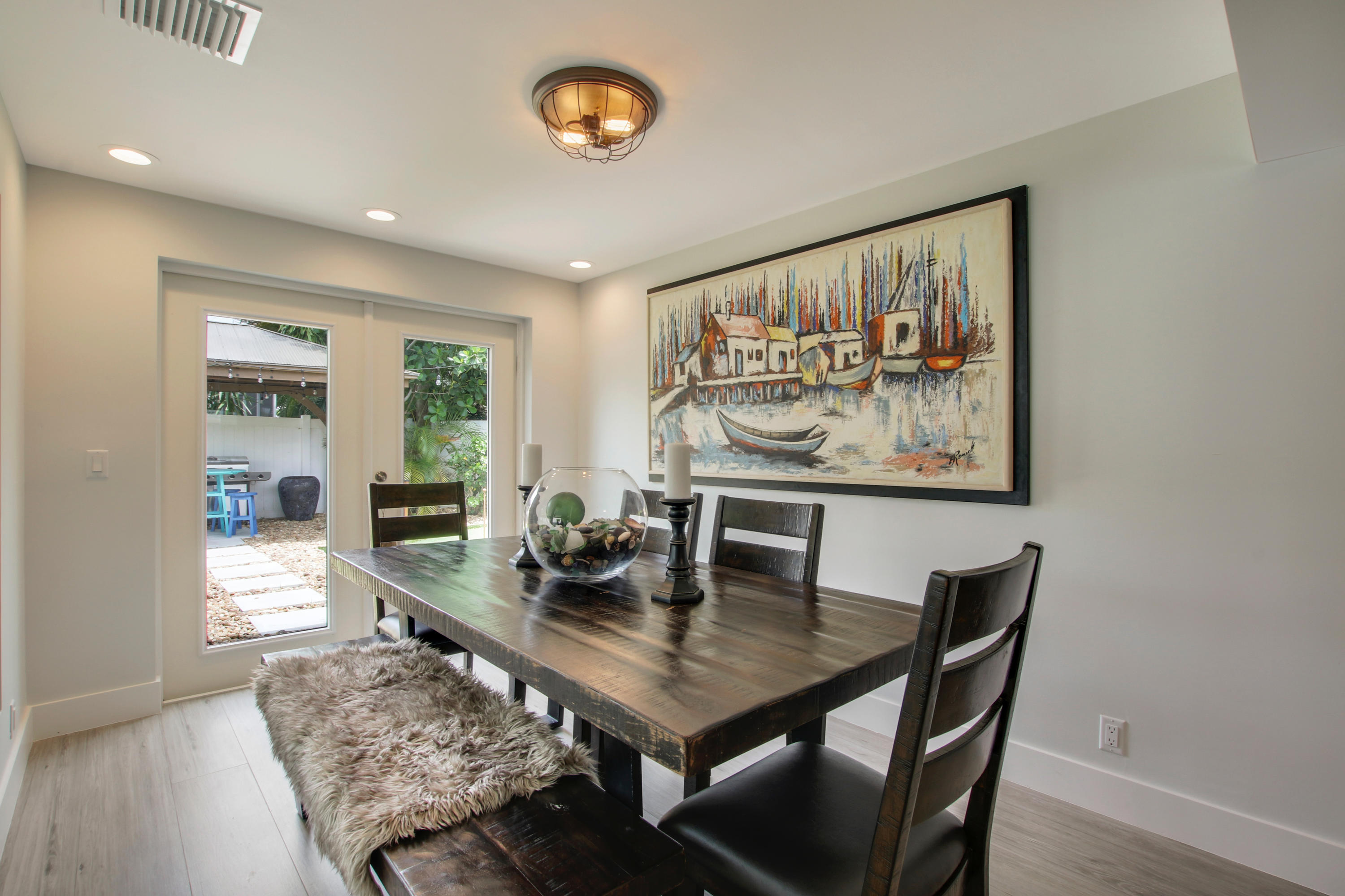 1150 Singer Drive Riviera Beach, FL 33404 - Photo 7 of 20 a view of a dining room with furniture and wooden floor