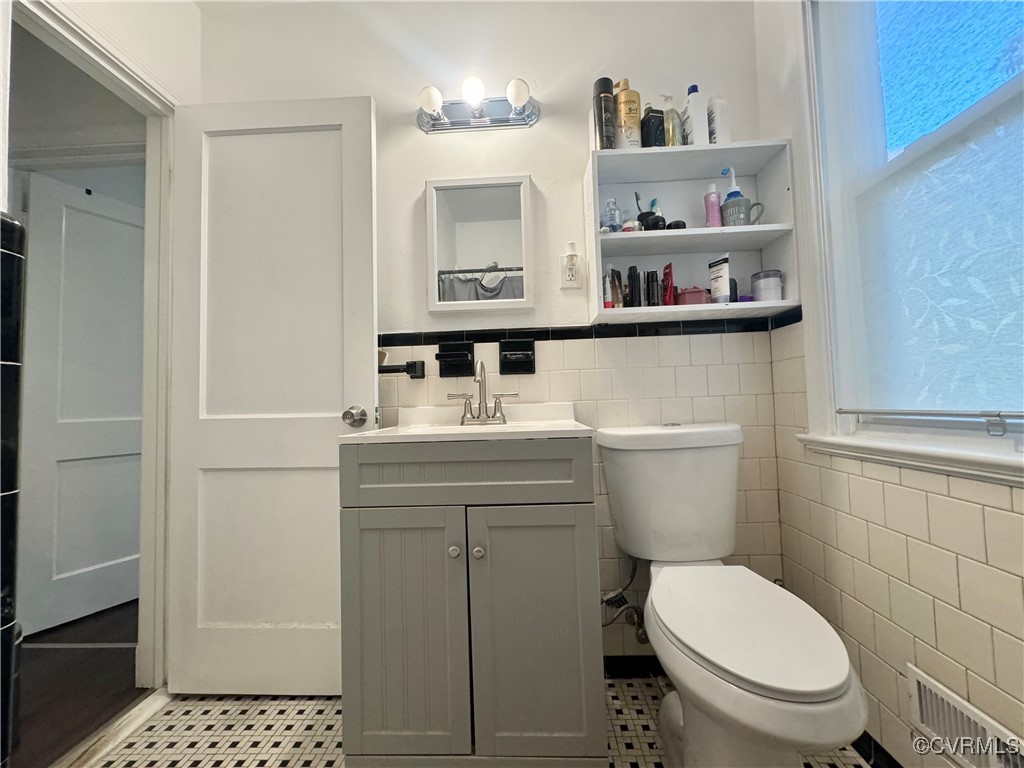 7300 Vernon Road Henrico, VA 23228 - Photo 15 of 20 Bathroom with toilet, vanity, tile walls, and tile