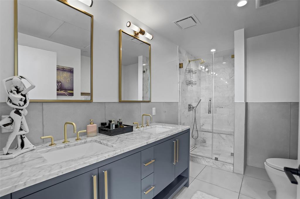 70 Rainey Street, Unit 1409 Austin, TX 78701 - Photo 15 of 38 Full bathroom featuring double vanity, a marble finish shower, and recessed lighting
