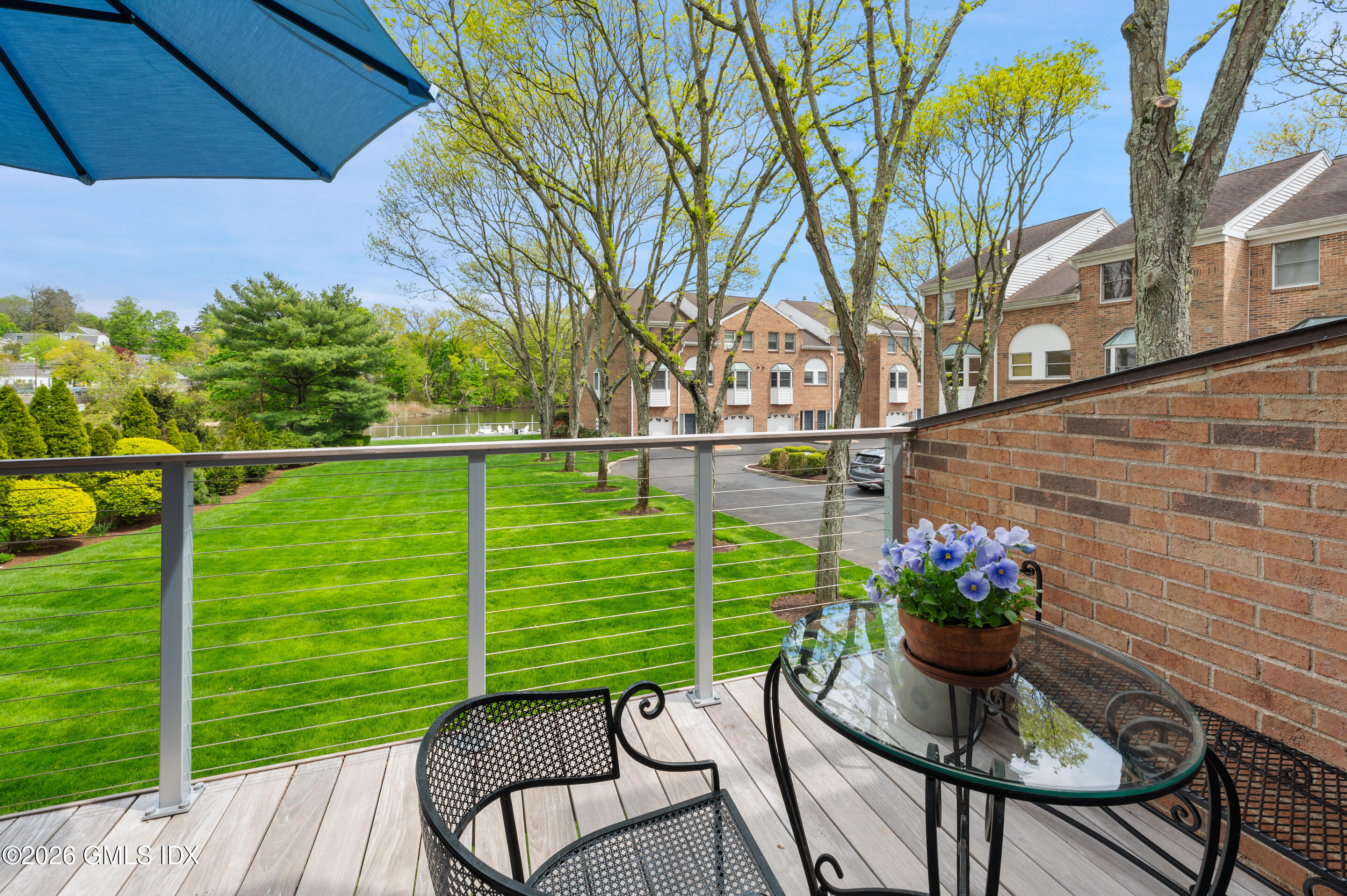 115 River Road, Unit 3 Cos Cob, CT 06807 - Photo 35 of 40 a view of a wooden chairs and table in the backyard
