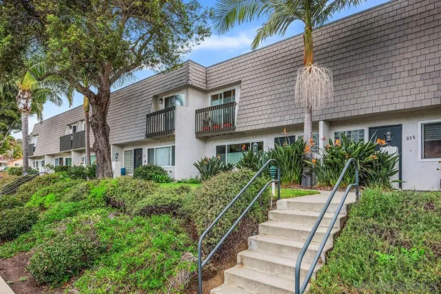 a view of a house with a yard and plants