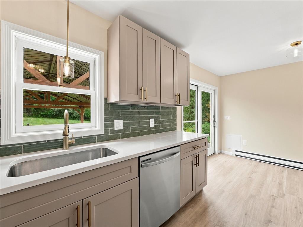 90 Gun Club Road Palmerton, PA 18071 - Photo 33 of 58 Crisp white countertops and modern cabinetry highlight this bright culinary workspace with outdoor views.