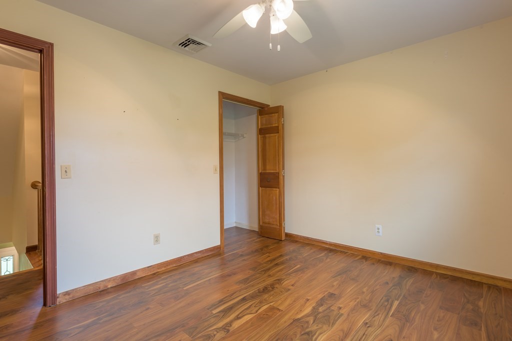 2 Wintergreen Circle Amherst, MA 01002 - Photo 16 of 37 an empty room with wooden floor and windows