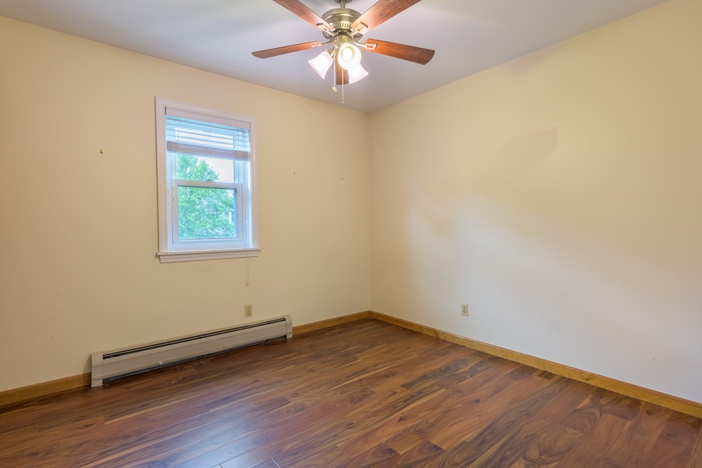 2 Wintergreen Circle Amherst, MA 01002 - Photo 17 of 37 an empty room with wooden floor and windows