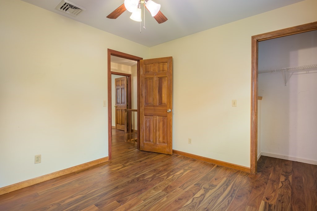 2 Wintergreen Circle Amherst, MA 01002 - Photo 18 of 37 an empty room with wooden floor and a ceiling fan