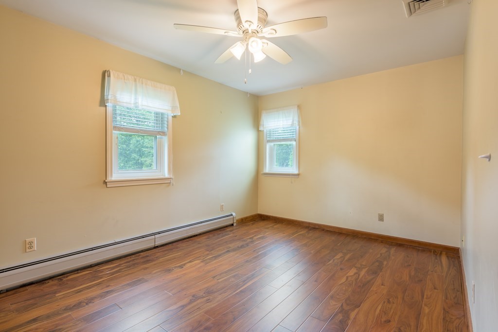 2 Wintergreen Circle Amherst, MA 01002 - Photo 19 of 37 a view of an empty room with wooden floor and a window