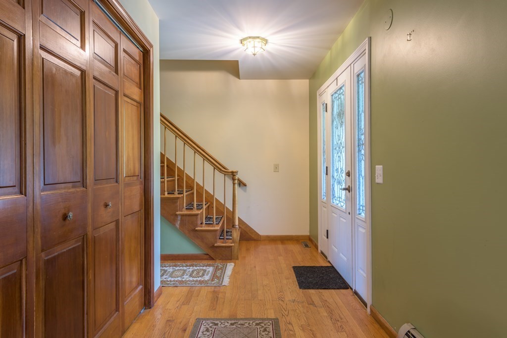2 Wintergreen Circle Amherst, MA 01002 - Photo 2 of 37 a view of a hallway with wooden floor and staircase