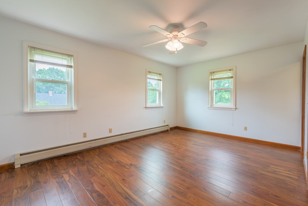 2 Wintergreen Circle Amherst, MA 01002 - Photo 21 of 37 a view of an empty room with wooden floor and a window