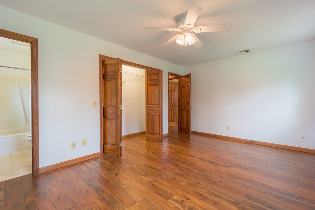 2 Wintergreen Circle Amherst, MA 01002 - Photo 22 of 37 an empty room with wooden floor and ceiling fan