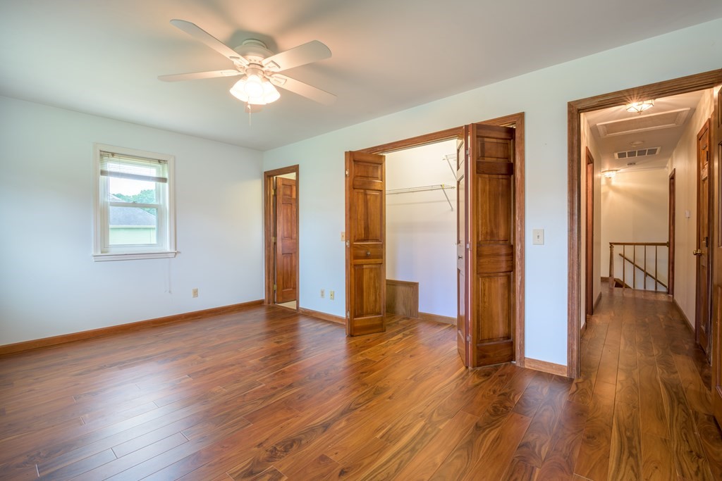 2 Wintergreen Circle Amherst, MA 01002 - Photo 23 of 37 a view of an empty room with window and wooden floor