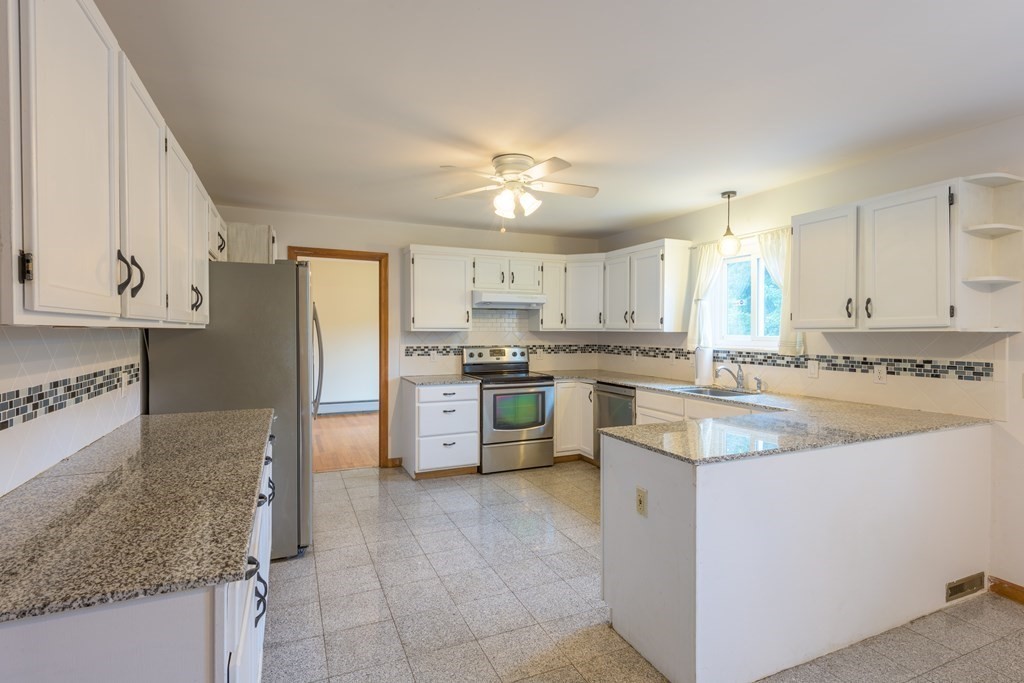 2 Wintergreen Circle Amherst, MA 01002 - Photo 4 of 37 a kitchen with stainless steel appliances granite countertop a refrigerator sink and cabinets