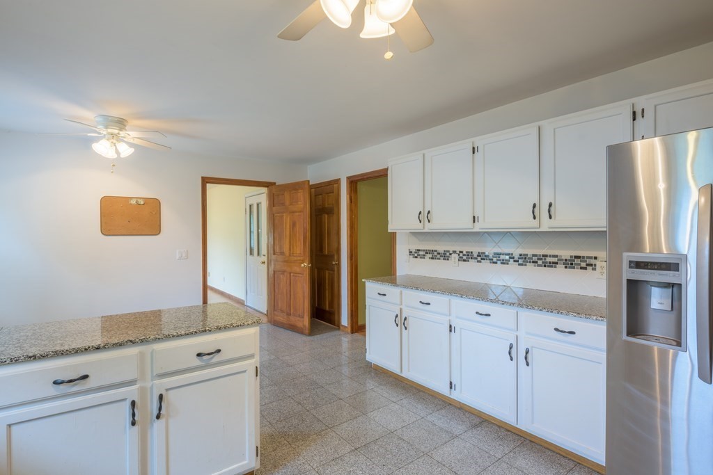 2 Wintergreen Circle Amherst, MA 01002 - Photo 5 of 37 a kitchen with granite countertop white cabinets and stainless steel appliances
