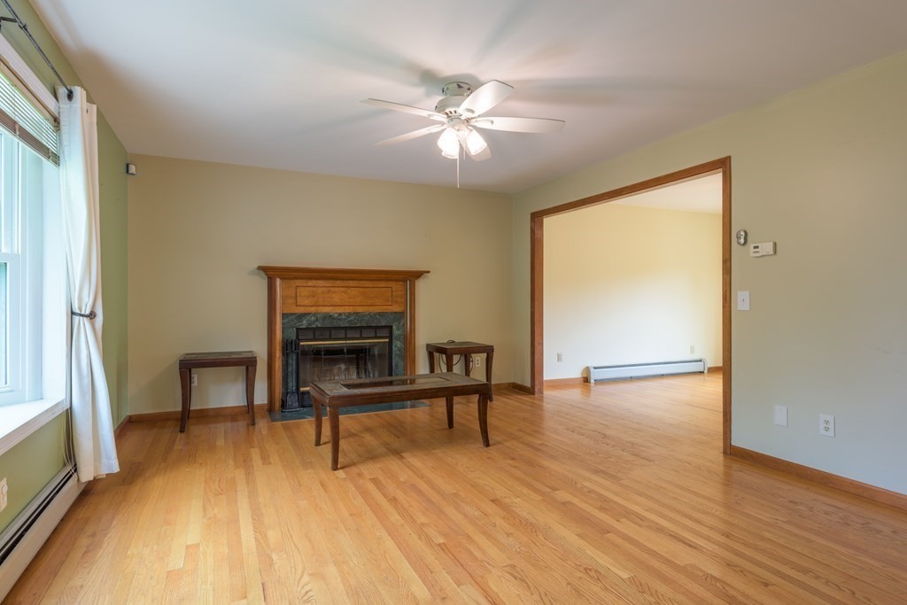 2 Wintergreen Circle Amherst, MA 01002 - Photo 8 of 37 a view of an empty room with wooden floor and a window