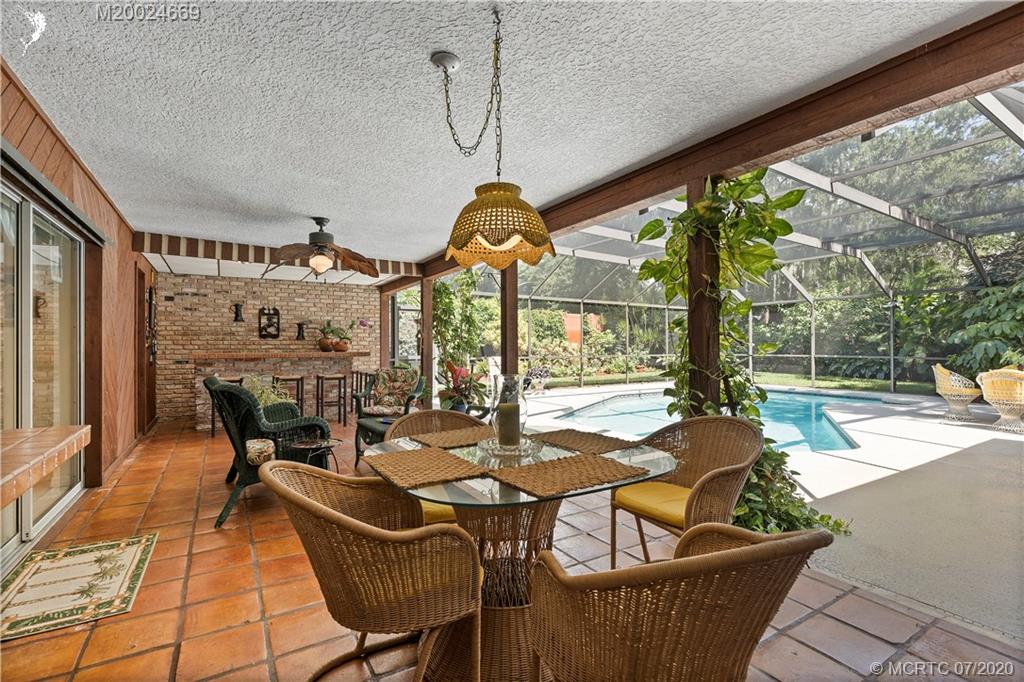 15 Banyan Road Stuart, FL 34996 - Photo 33 of 52 350 sq ft roofed porch with Mexican Tile Poolside.