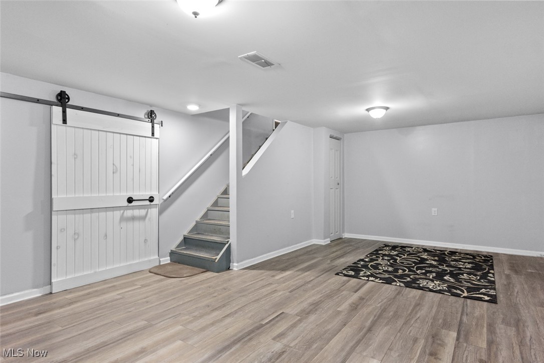 1824 Amherst Road Northeast Massillon, OH 44646 - Photo 30 of 34 Basement featuring style floors and a barn door