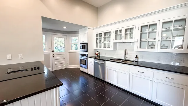 a kitchen with granite countertop a stove and a refrigerator