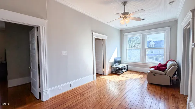 a view of a hallway with wooden floor