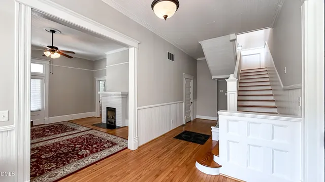 a view of an entryway with wooden floor and staircase