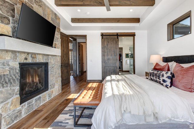 1282 Chimney Rock Road, Unit 344 Heber City, UT 84032 - Photo 26 of 55 Stone-faced fireplace with a substantial hearth, complemented by wood-finish flooring