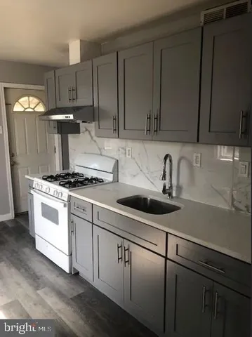 a kitchen with kitchen island a sink stainless steel appliances and cabinets