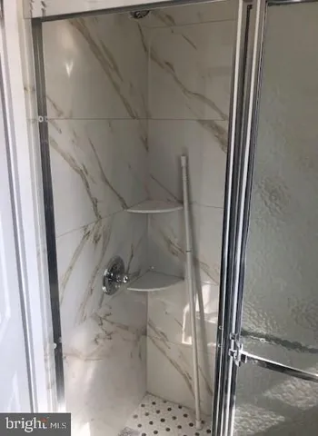 a bathroom with a glass door shower