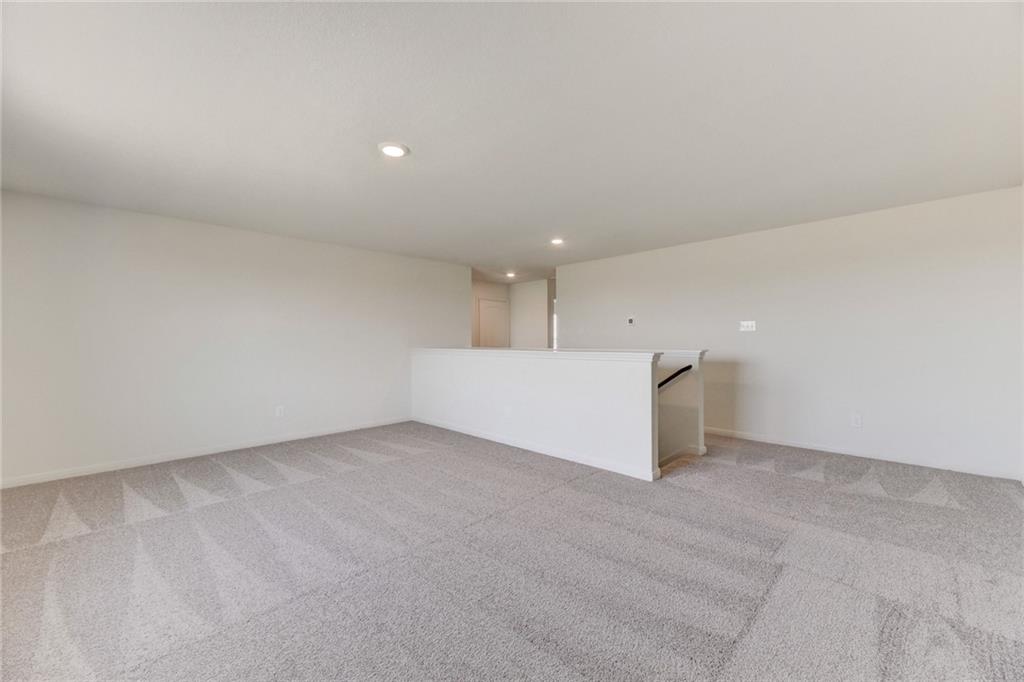 105 Brunswick Lane Jarrell, TX 76537 - Photo 11 of 16 Unfurnished room featuring light colored carpet and recessed lighting