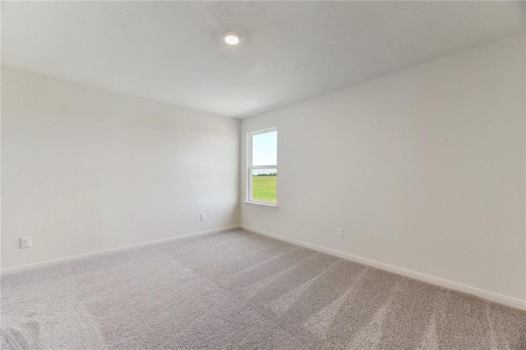 105 Brunswick Lane Jarrell, TX 76537 - Photo 12 of 16 Carpeted spare room with baseboards