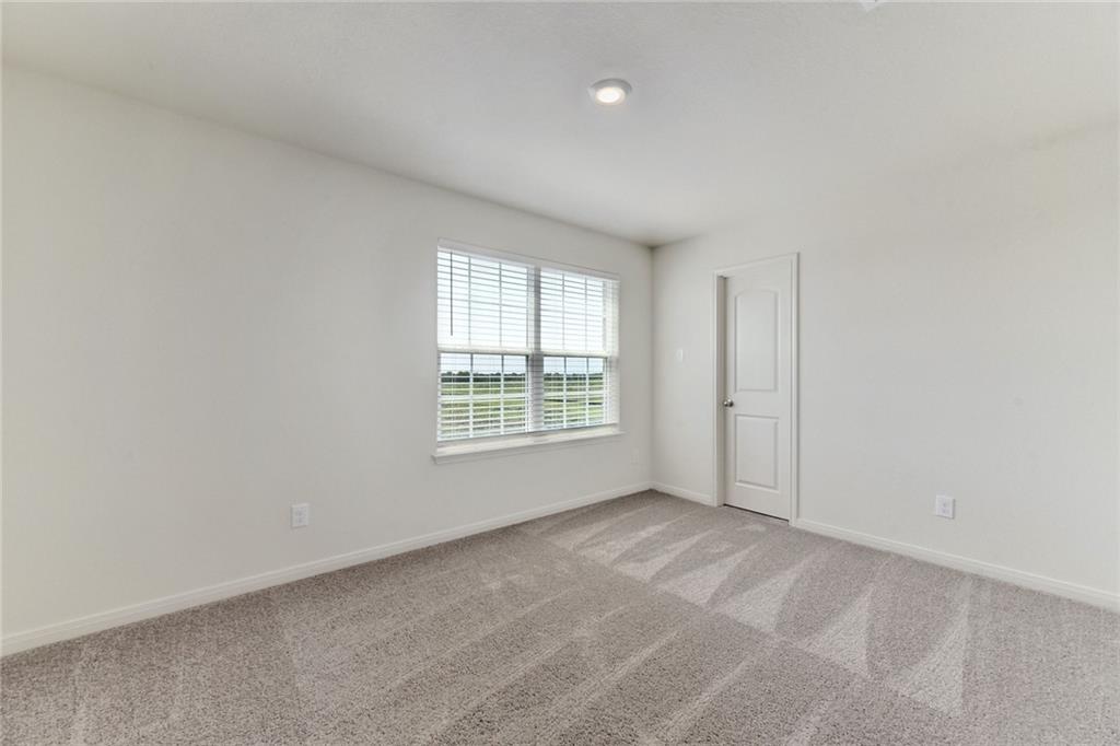 105 Brunswick Lane Jarrell, TX 76537 - Photo 14 of 16 Spare room featuring baseboards and light carpet