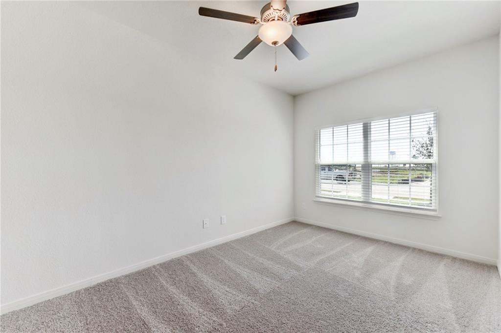 105 Brunswick Lane Jarrell, TX 76537 - Photo 15 of 16 Spare room with light colored carpet and a ceiling fan