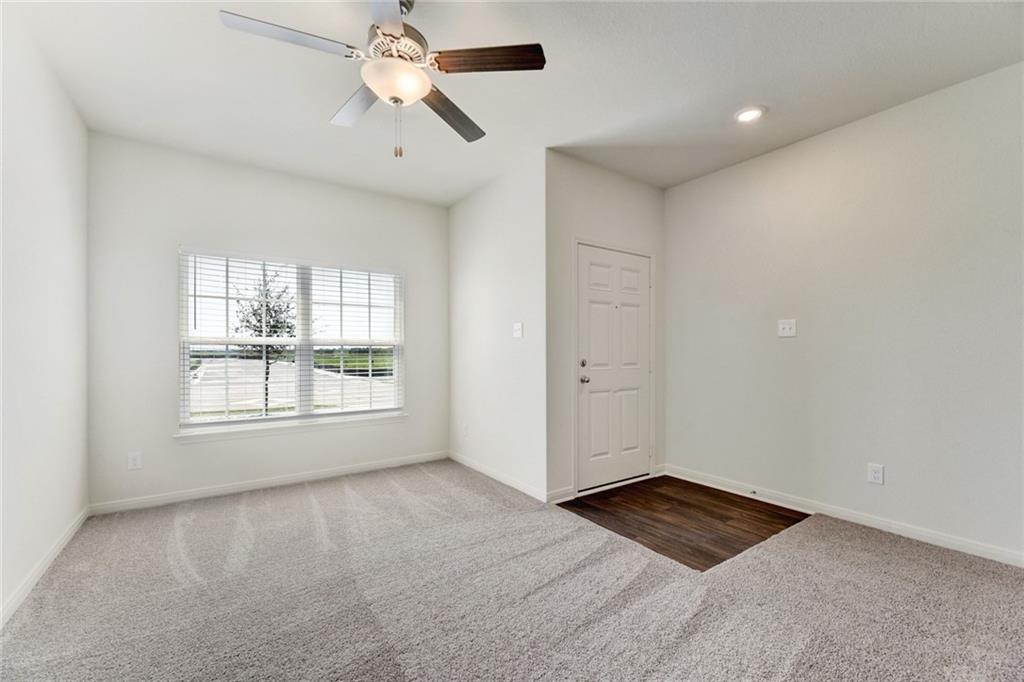 105 Brunswick Lane Jarrell, TX 76537 - Photo 3 of 16 Unfurnished room with dark carpet, a ceiling fan, and recessed lighting