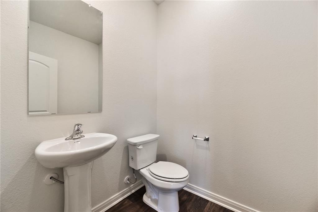 105 Brunswick Lane Jarrell, TX 76537 - Photo 4 of 16 Bathroom featuring a textured wall and dark wood-style floors