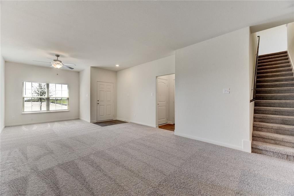 105 Brunswick Lane Jarrell, TX 76537 - Photo 6 of 16 Empty room featuring carpet floors, ceiling fan, and recessed lighting