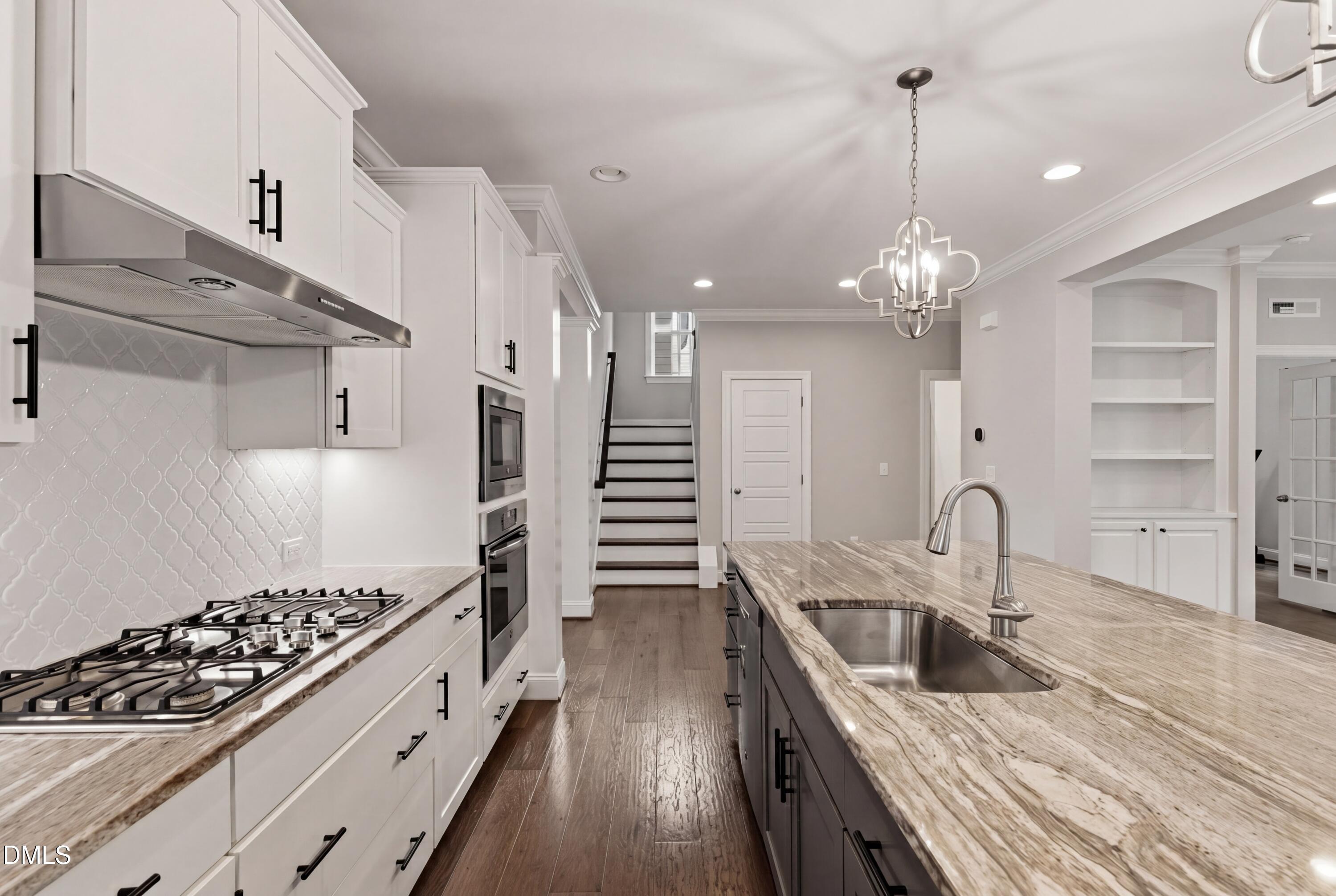 7421 Stonehenge Farm Lane Raleigh, NC 27613 - Photo 4 of 48 a kitchen with sink stove and cabinets