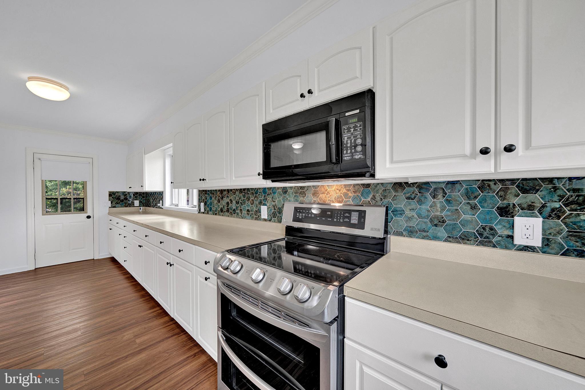 145 Hopewell - Wertsville Road Hopewell, NJ 08525 - Photo 11 of 39 a kitchen with stainless steel appliances white cabinets and a stove top oven