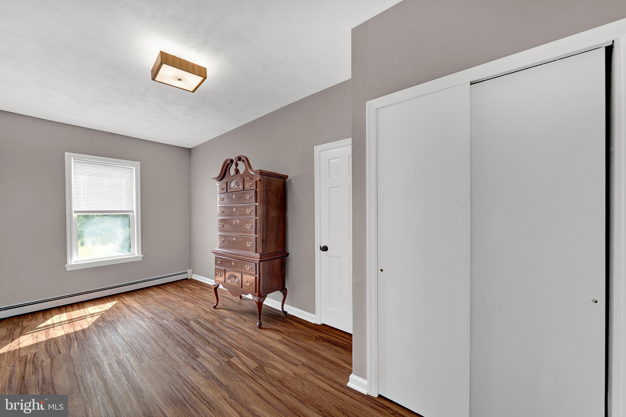 145 Hopewell - Wertsville Road Hopewell, NJ 08525 - Photo 17 of 39 a view of an empty room with wooden floor and a window